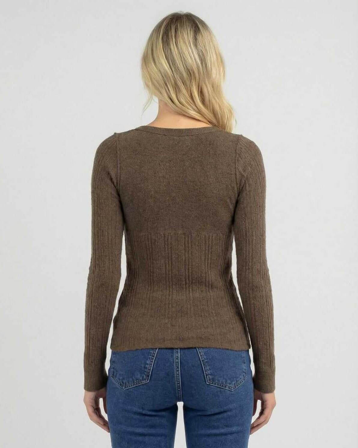 Back view of a woman wearing the Lauven Monaco Long Sleeve, a brown ribbed knit shirt designed for a sleek slim fit.