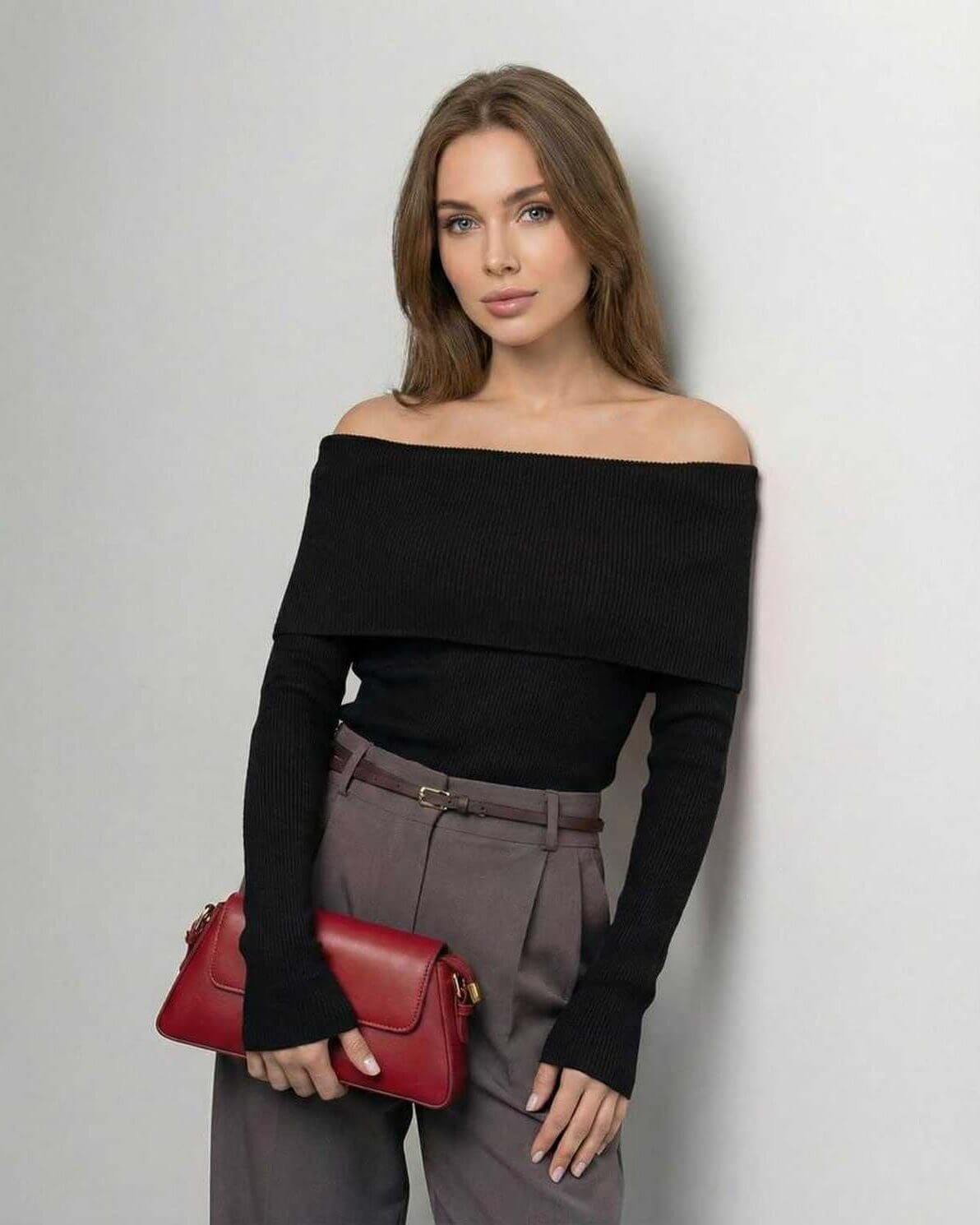 Model wearing Lauven Monaco Top, an off-the-shoulder black long sleeve slim fit top, paired with stylish trousers.