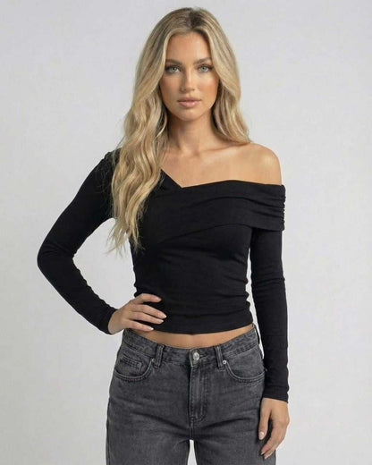 Vela Long Sleeve by Lauven showcasing a woman in a black off-the-shoulder top with a draped design.