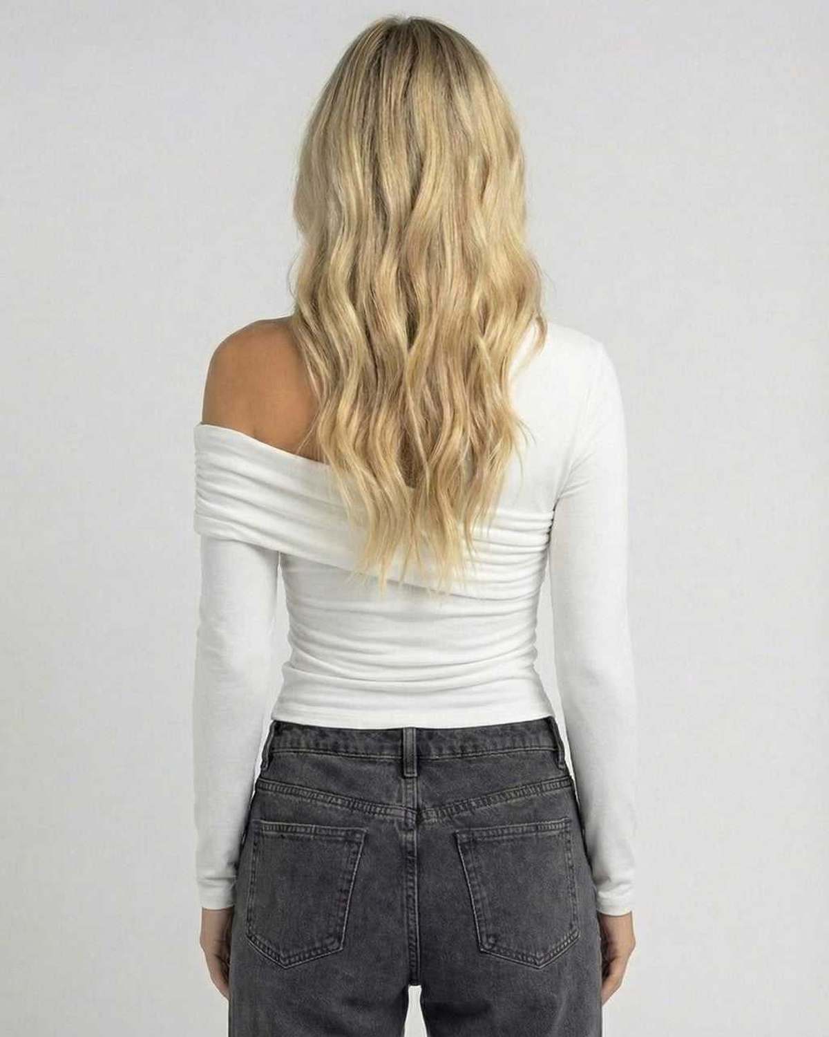 Back view of a model wearing the Lauven Lyra Long Sleeve off-the-shoulder top in white, showcasing elegant design and fit.