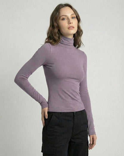 Model wearing a sleek Lilac Nova Long Sleeve top by Lauven, showcasing a high round neckline and long sleeves.