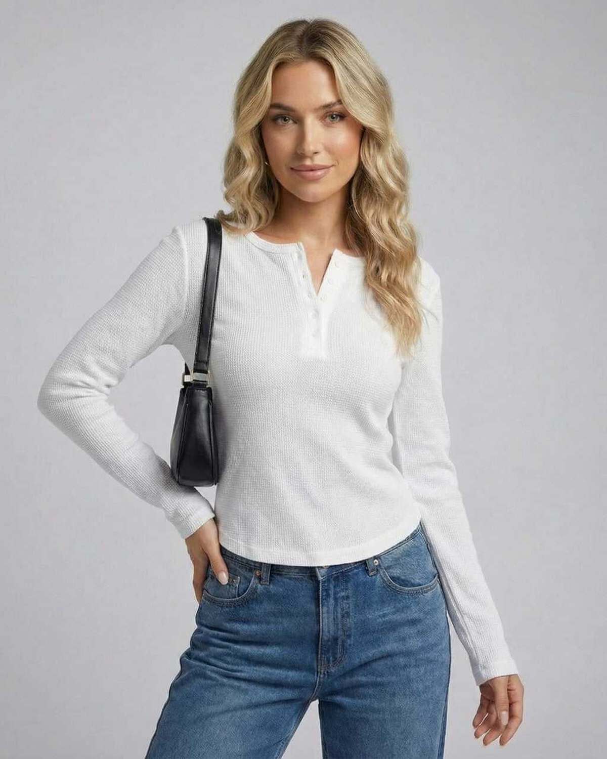 Nara Long Sleeve top by Lauven featuring a woman wearing a white long sleeve round neck design with casual jeans.