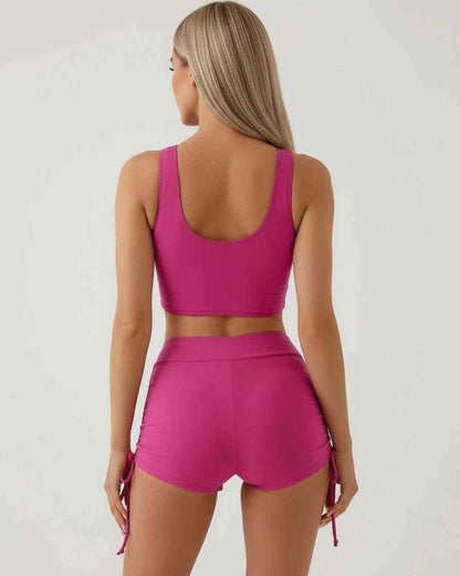 Back view of Malibu Set by Lauven, featuring a pink sleeveless crop top and high waist shorts.