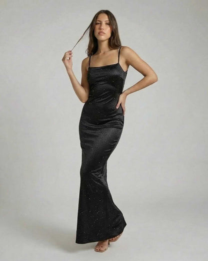 Elegant model showcasing the Noir Maxi Dress by Lauven, featuring spaghetti straps and sparkling sequin details.
