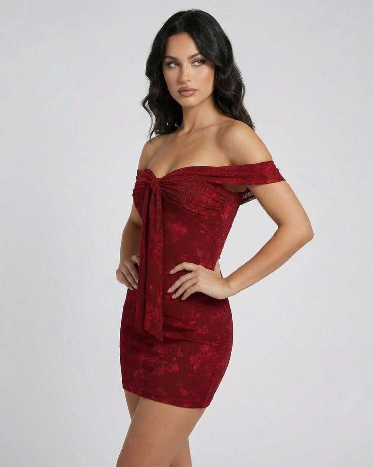 Model showcasing the Lauven Verona Mini Dress in rich red, featuring a jacquard sheath silhouette and off-the-shoulder design.