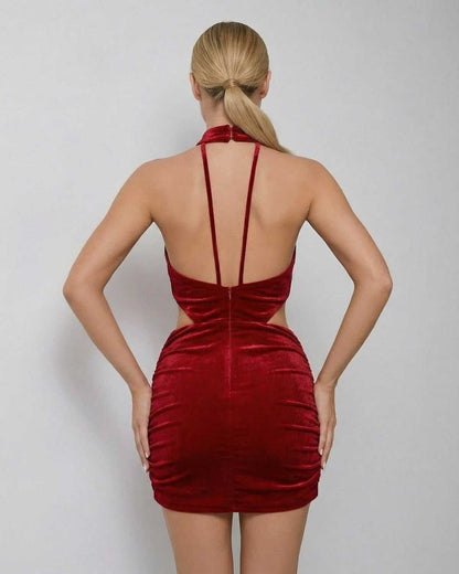 Valencia Mini Dress by Lauven in red velvet, showcasing the sleeveless halter neck and bodycon fit from the back.