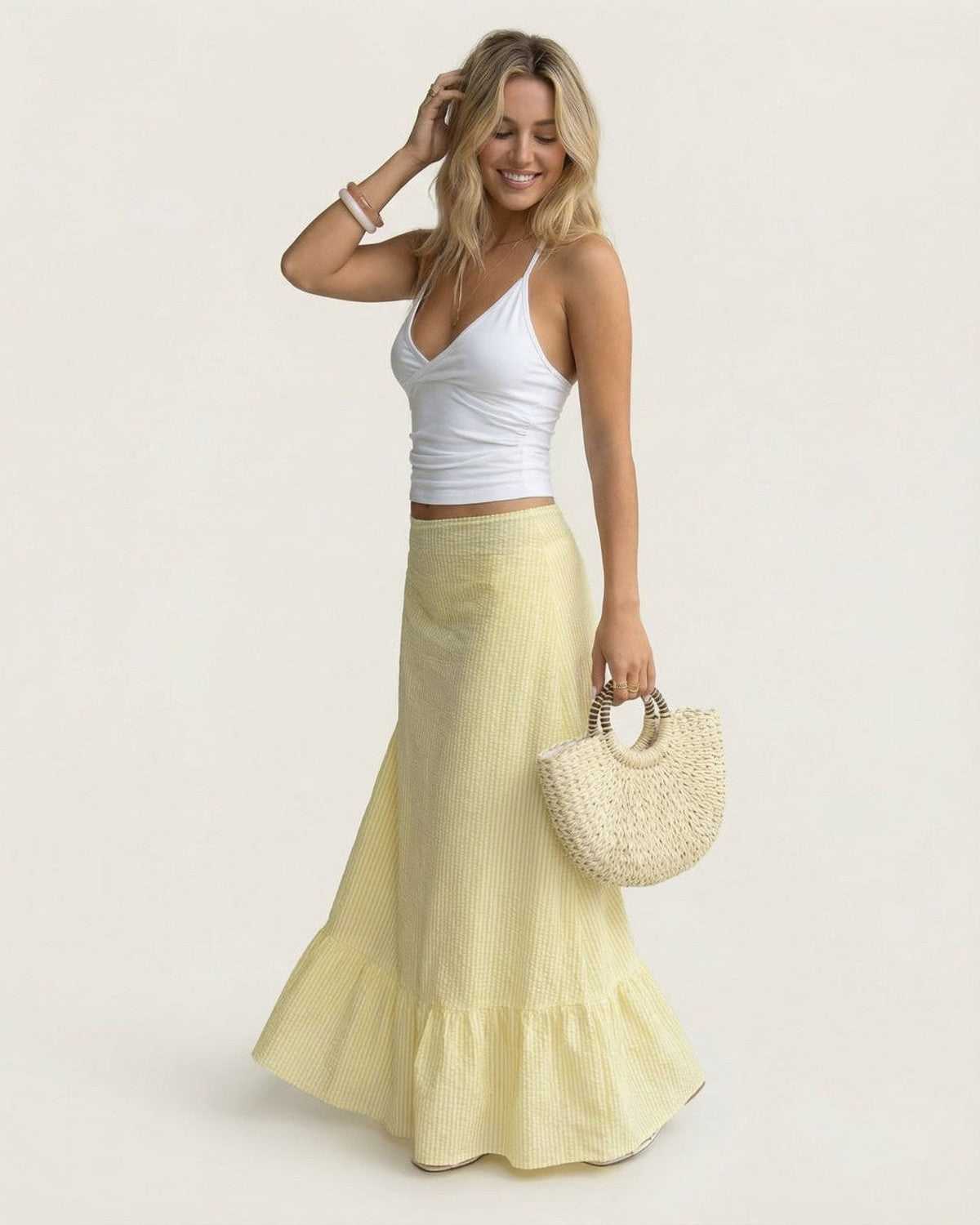 Model wearing Solara Maxi Skirt by Lauven, showcasing its flared silhouette and soft striped texture.