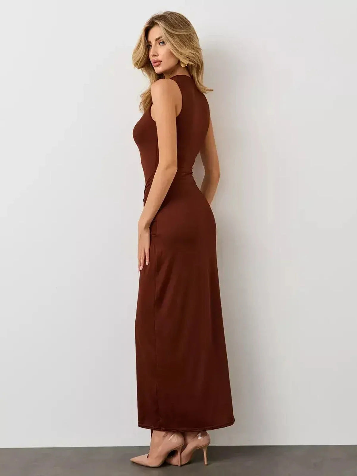 Side view of Mocha Muse Maxi Dress in warm brown, showcasing its sculptural fit and elegant drape.