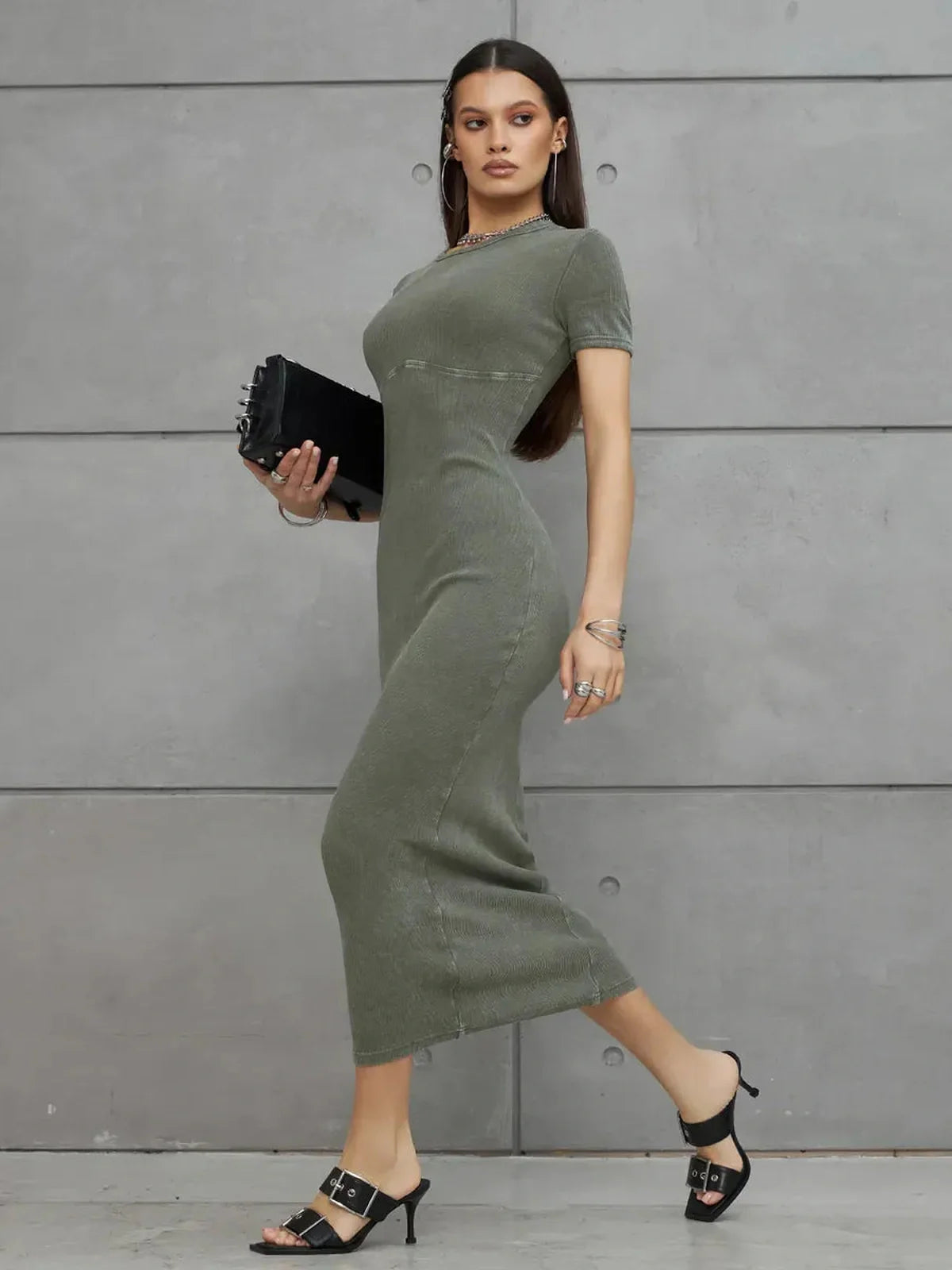 Model showcasing the Olive Line Maxi Dress in khaki green, offering a chic, minimalistic silhouette.