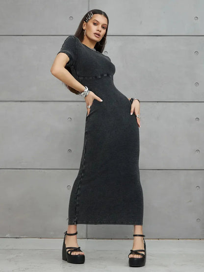 Graphite Form Maxi Dress showcasing a sculpted fit and edgy silhouette against a minimalist backdrop.