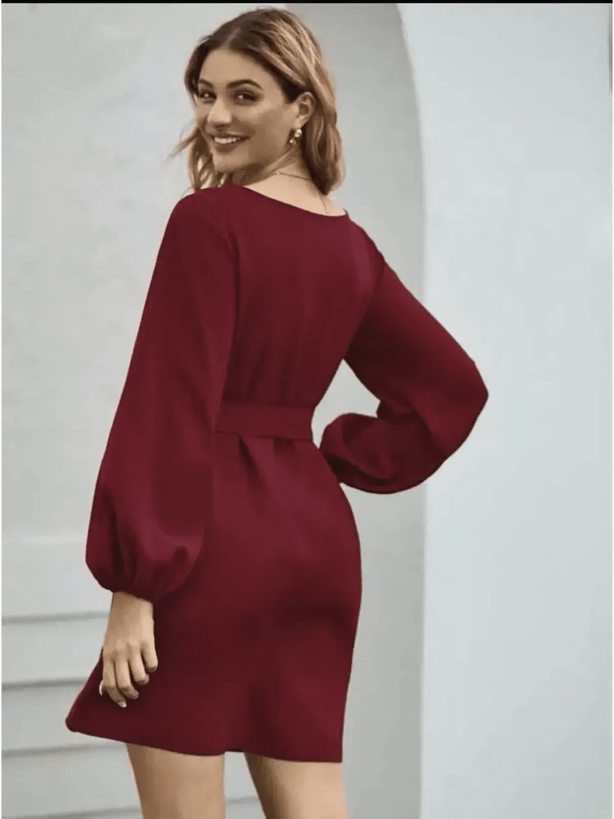 Elegant burgundy mini dress with voluminous long sleeves and a cinched waist, perfect for wedding guests or formal occasions.