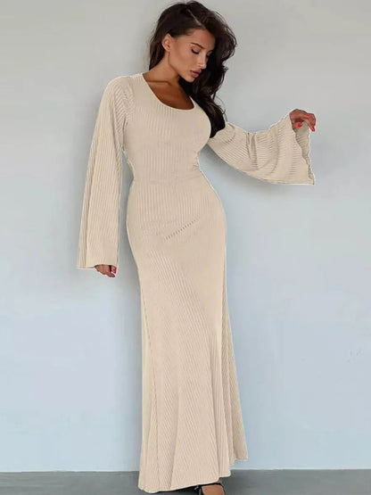Sculpted Elegance Maxi Dress in soft ribbed texture, featuring a flattering silhouette and dramatic statement sleeves.