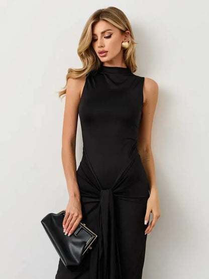 Model wearing an elegant Obsidian Drape Maxi Dress, featuring a high neckline and dramatic knotted draping.