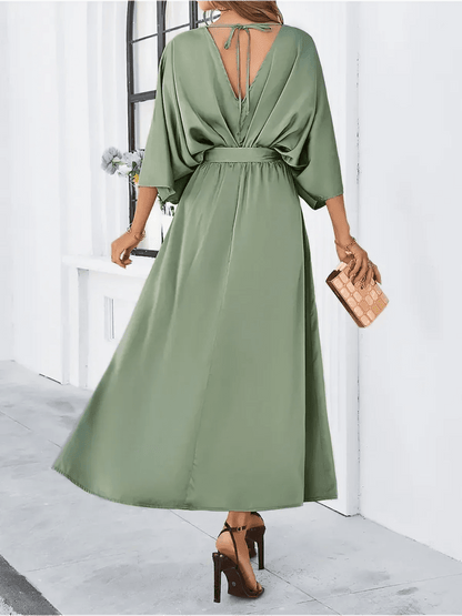 Back view of the Serenity Maxi Dress in green with kimono sleeves and adjustable waist tie, perfect for elegant occasions.