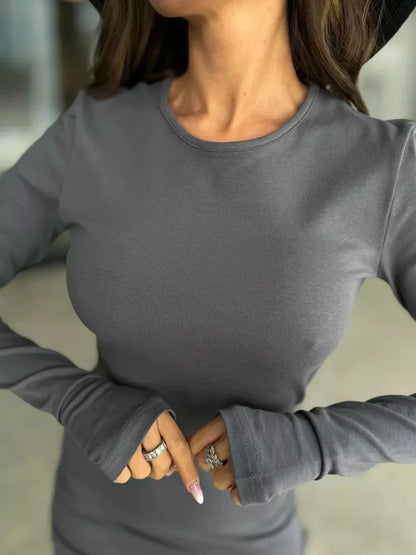 Stylish woman in long sleeve graphite gray mini dress, showcasing a trendy and chic outfit for various occasions.