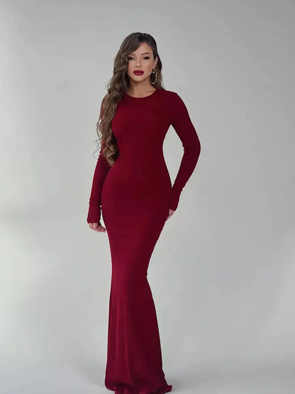 Elegant burgundy long sleeve maxi dress featuring a sleek silhouette and luxe stretch fabric.