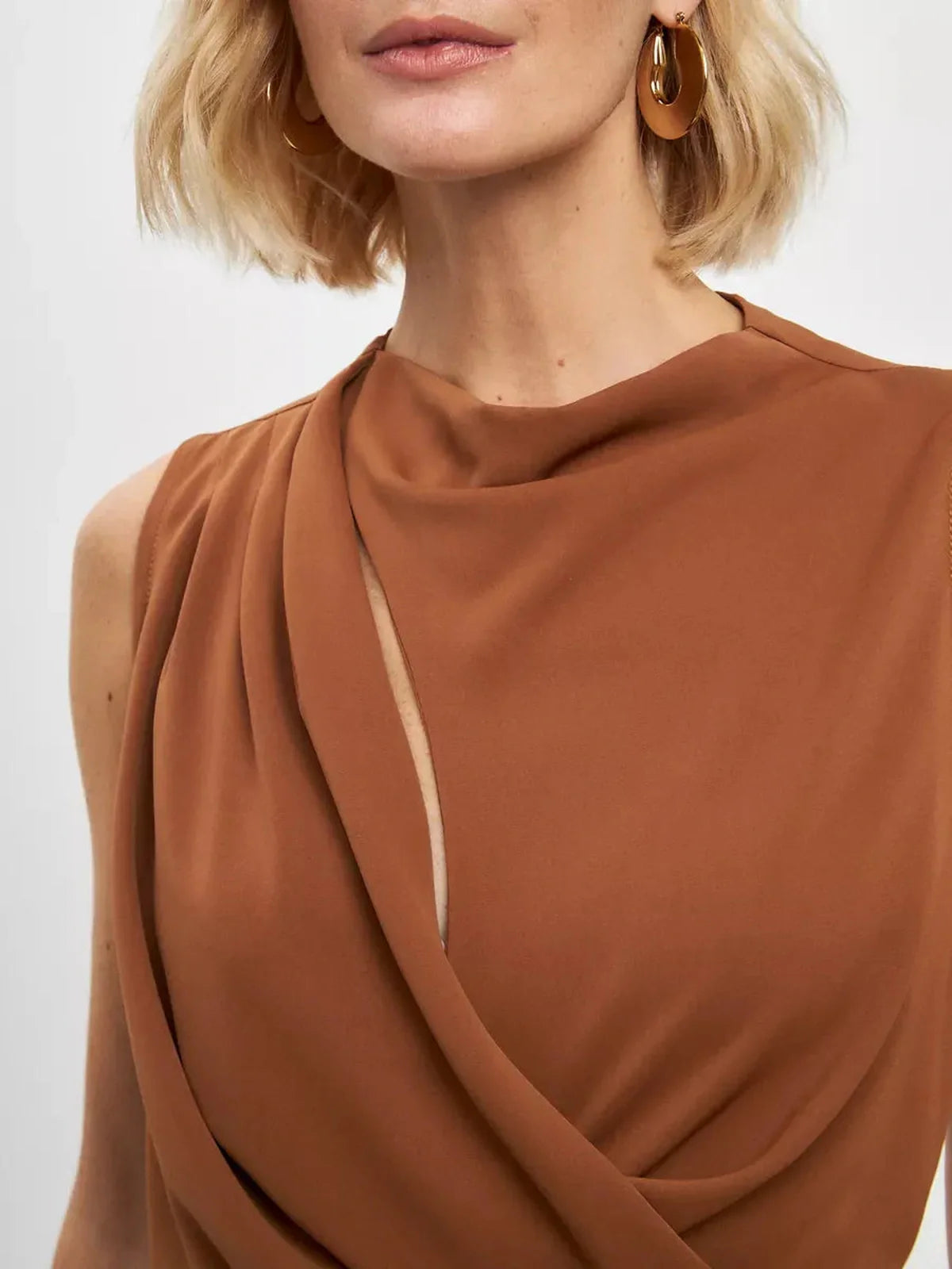 Close-up of the Sculpted Drape Maxi Dress showcasing its elegant light brown draping and refined neckline.