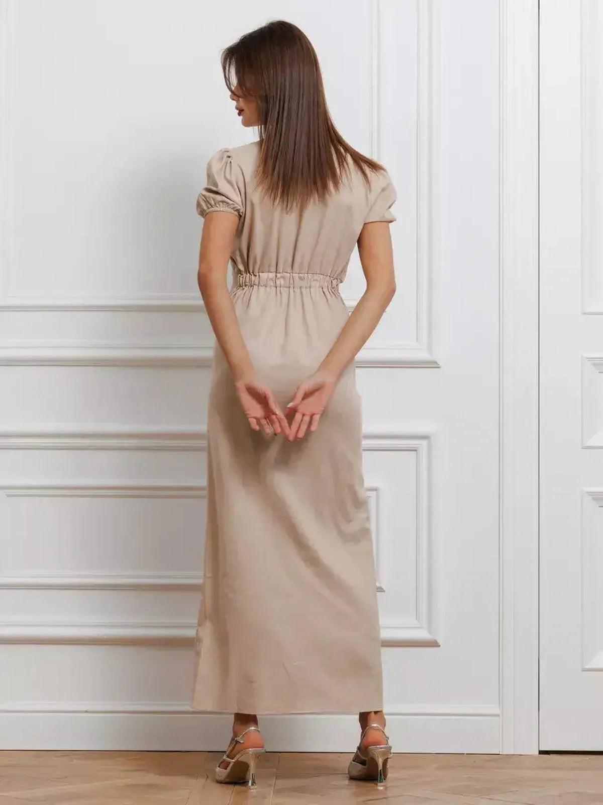 Back view of Serene Bond Maxi Dress featuring puff sleeves and a gathered waist, showcasing its elegant silhouette.