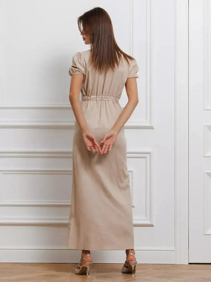 Back view of Serene Bond Maxi Dress featuring puff sleeves and a gathered waist, showcasing its elegant silhouette.