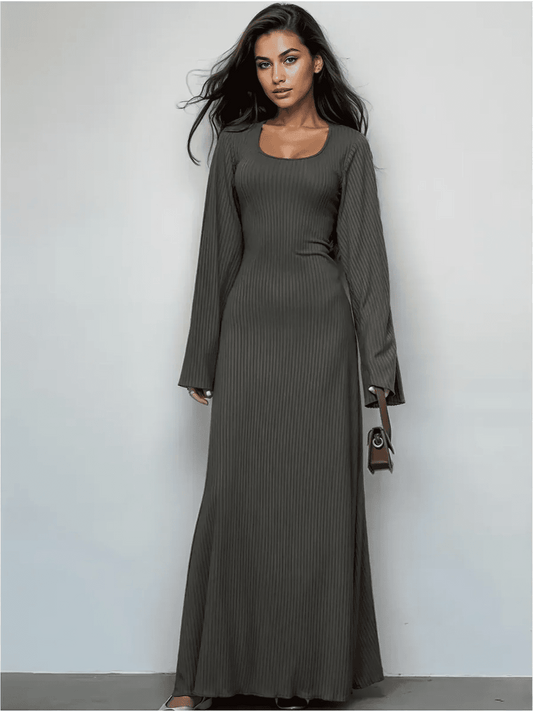 Elegant granite luxe maxi dress with a sculpting fit and flared sleeves, perfect for day-to-dusk styling.