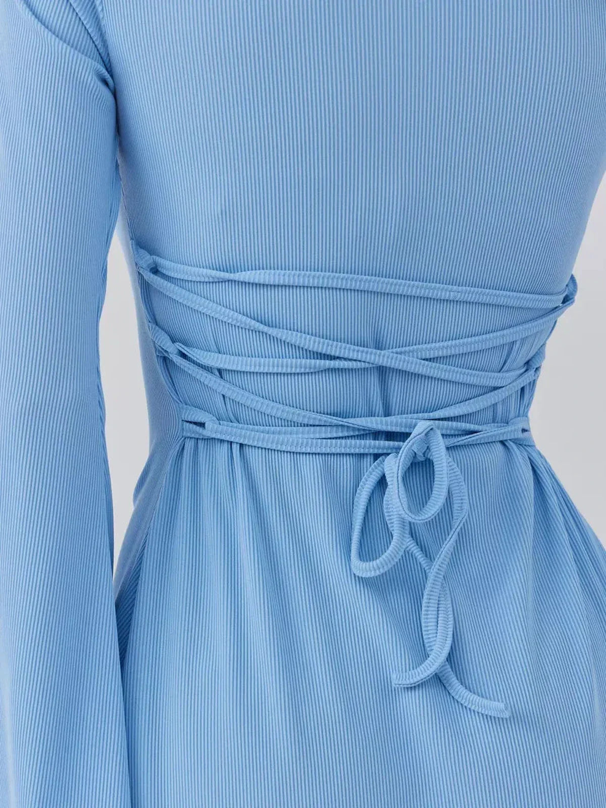 Back view of the Skyline Cutout mini dress showcasing the chic lace-up design in textured sky blue ribbed knit.