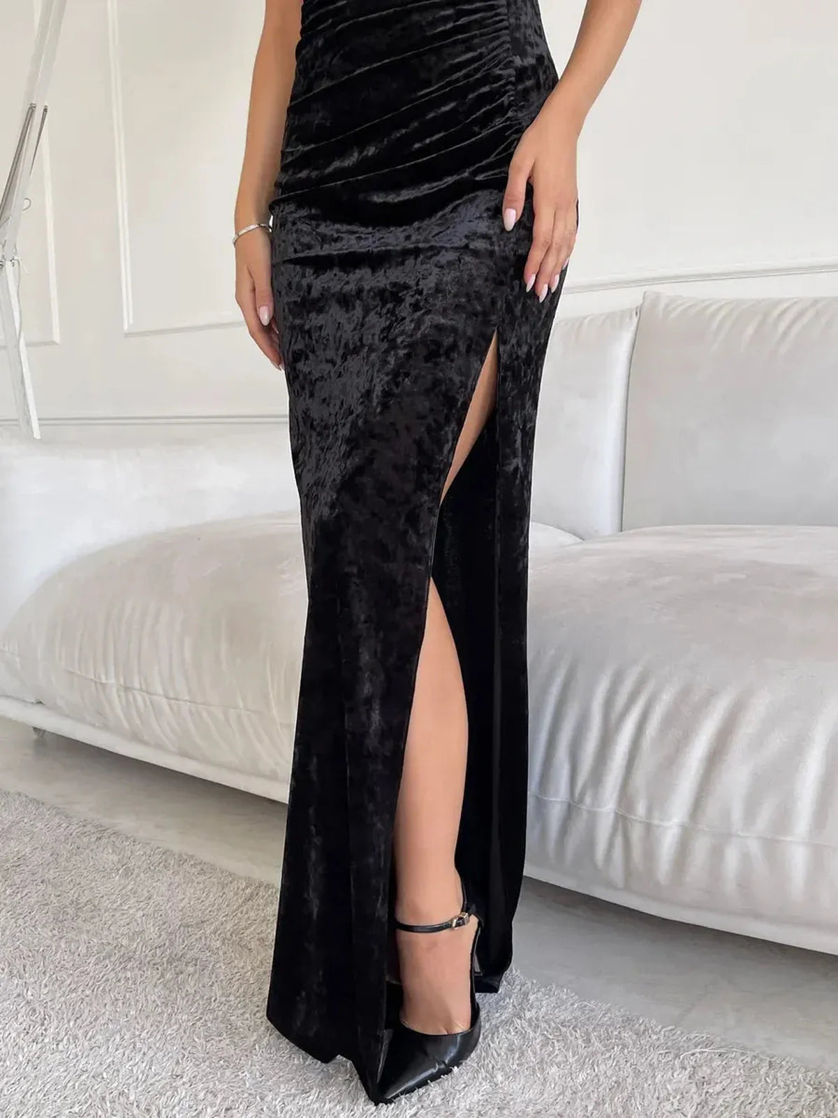 Noir Muse Maxi Dress in black velvet showcasing a sultry thigh-high slit and elegant sculpted fit.