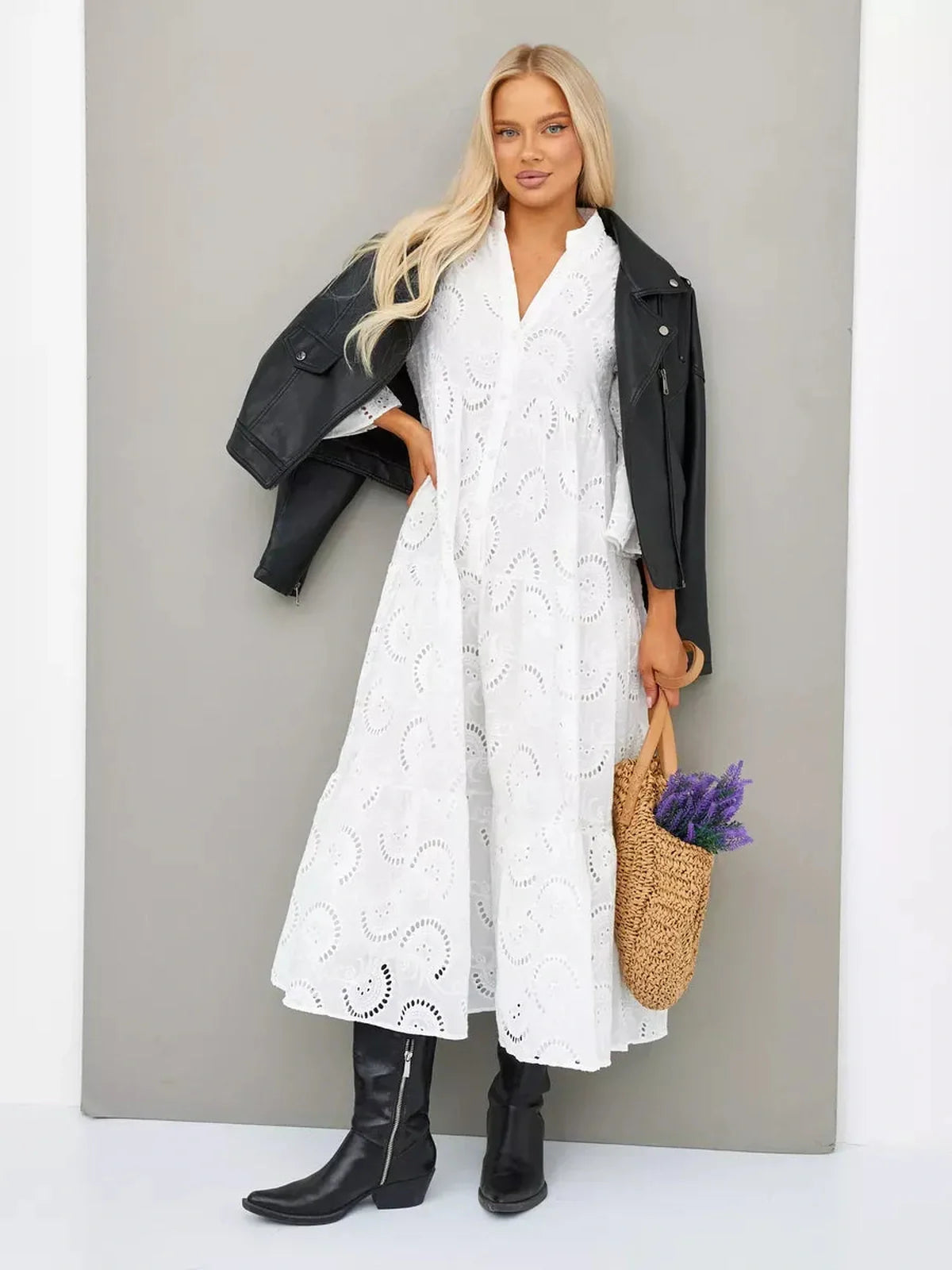 Model wearing a Broderie Cotton Maxi Dress with flared sleeves and a V-neck, styled with a leather jacket and accessories.
