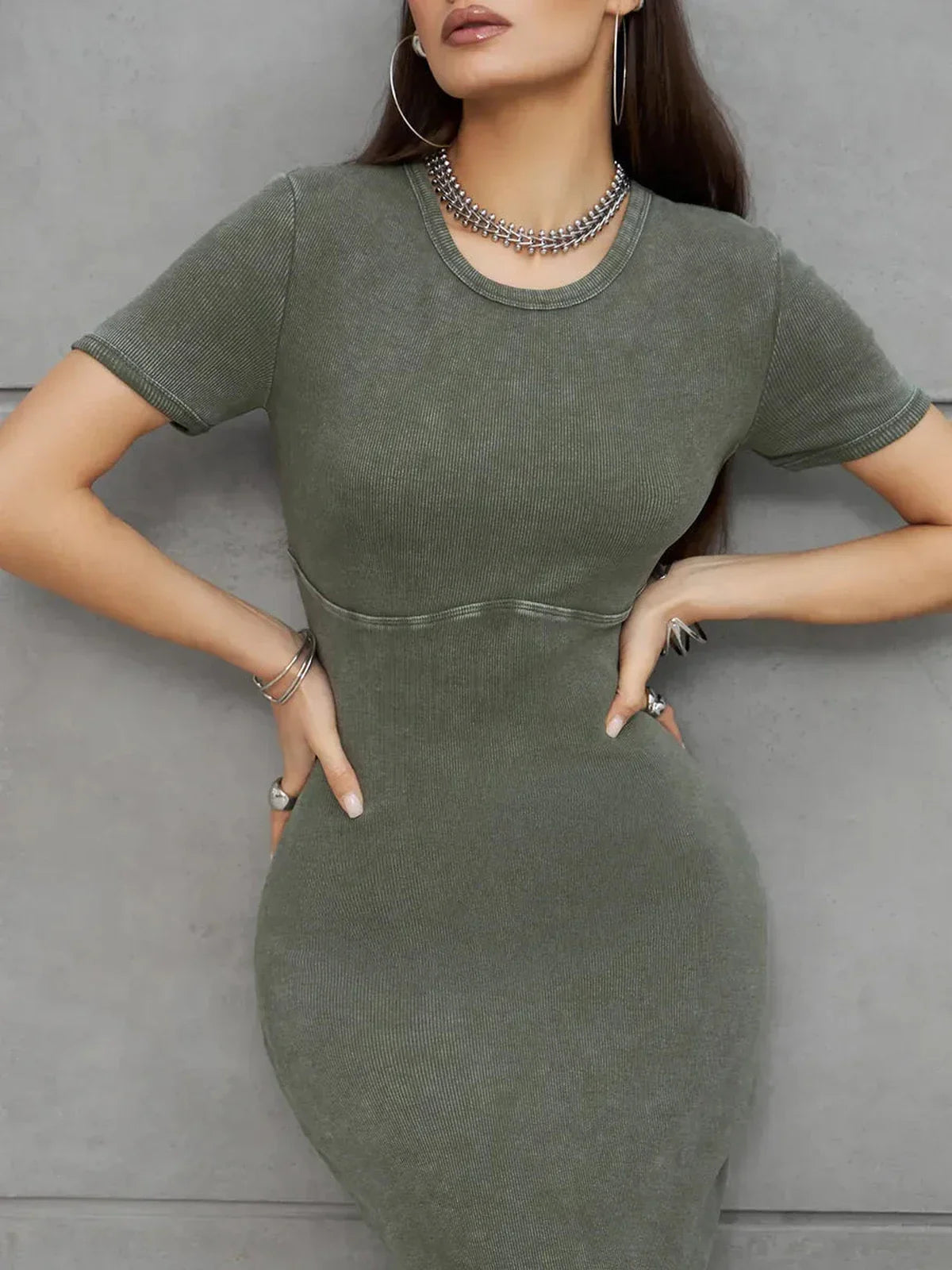 Model showcasing the Olive Line Maxi Dress in khaki green ribbed cotton with chic minimalist design.