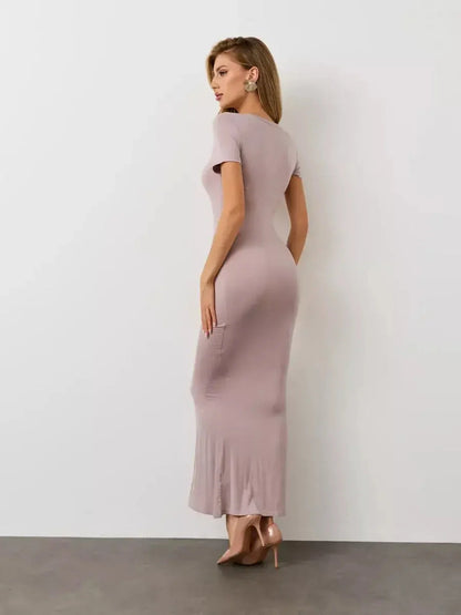 Model showcasing the Bare Essence Maxi Dress in neutral beige, highlighting its sculpted silhouette and flared hem.
