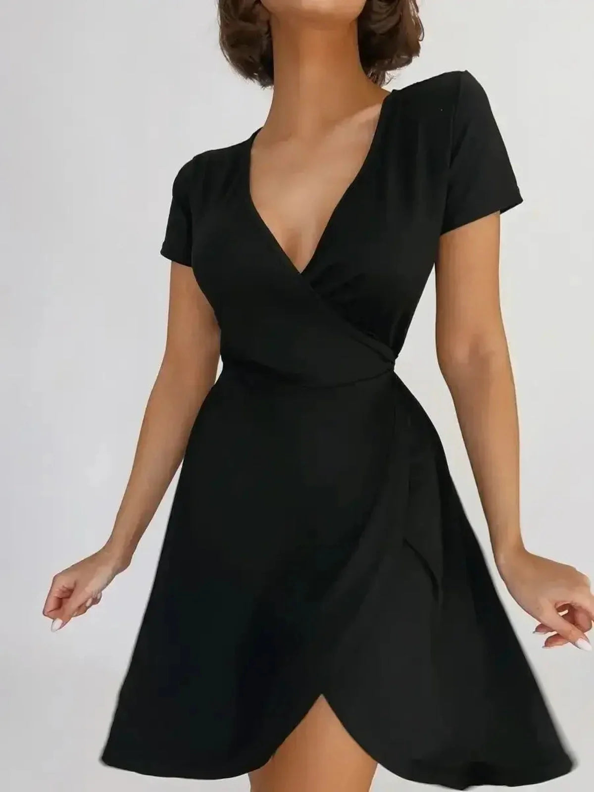 Sleek black mini dress with V-neckline and wrap design, perfect for any occasion.