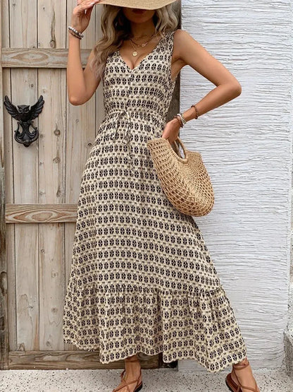 Solana Maxi Dress featuring a boho-inspired print, V-neckline, and tiered skirt, perfect for summer outings.