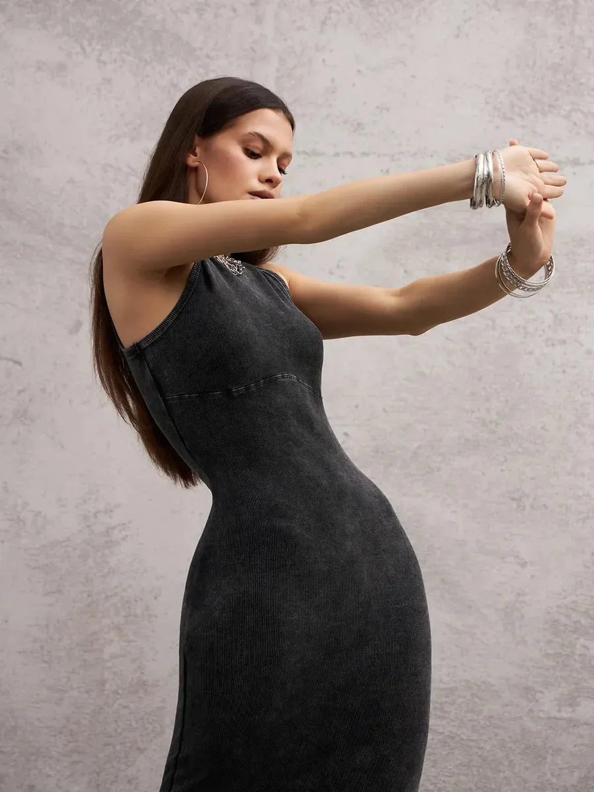 Model showcasing the Shadow Curve Maxi Dress in graphite, highlighting its sleek fit and minimalist design.