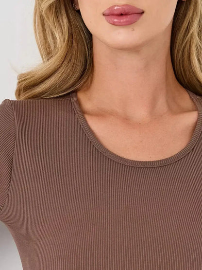 Close-up of a model wearing a mocha-colored long sleeve dress with a U-neckline, highlighting its elegant style.