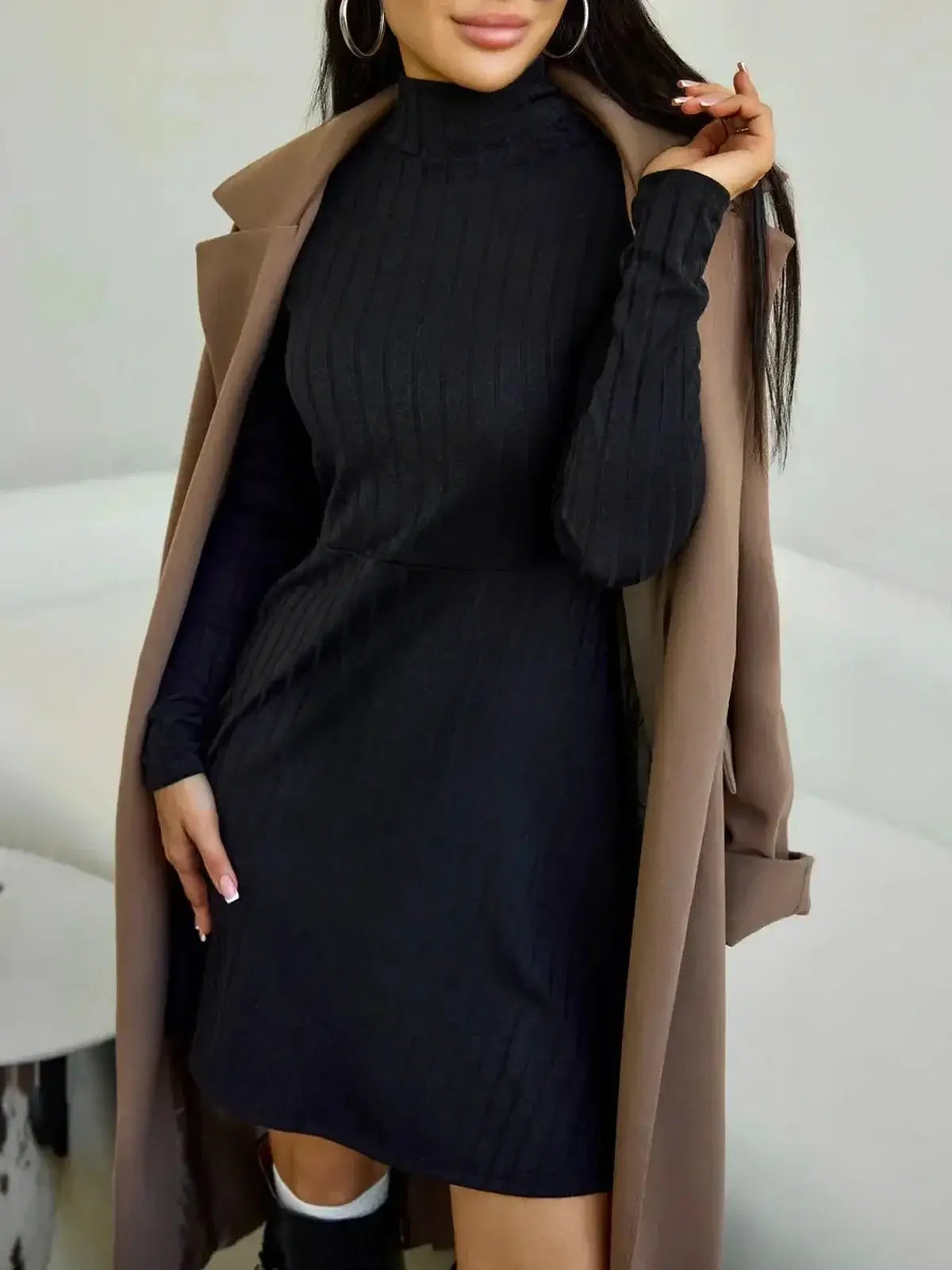 Elegant black ribbed cotton mini dress with high stand collar, paired with a stylish outerwear.