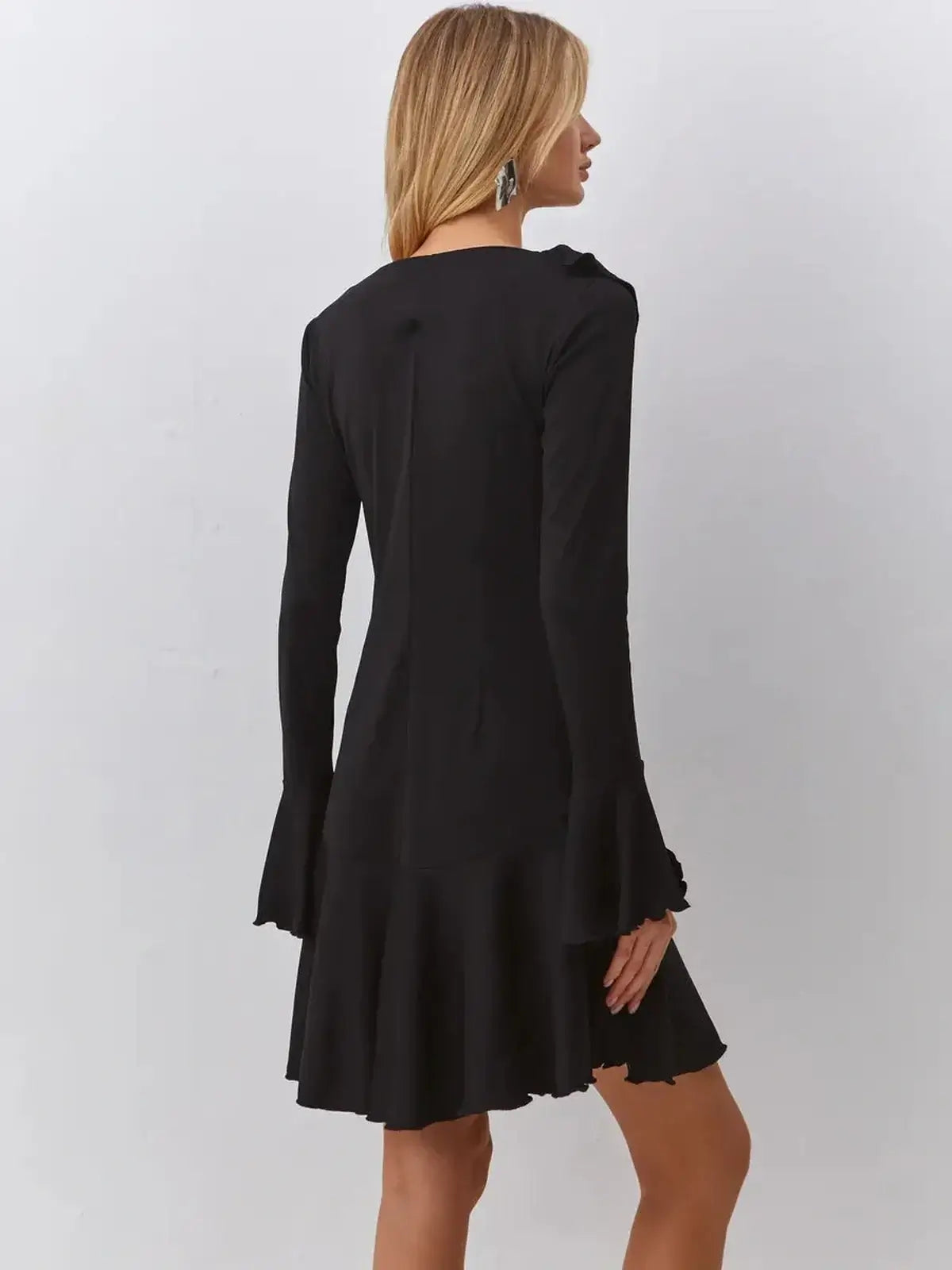 Back view of Velvet Noir black midi dress with ruffled sleeves, perfect for wedding guest and cocktail events.