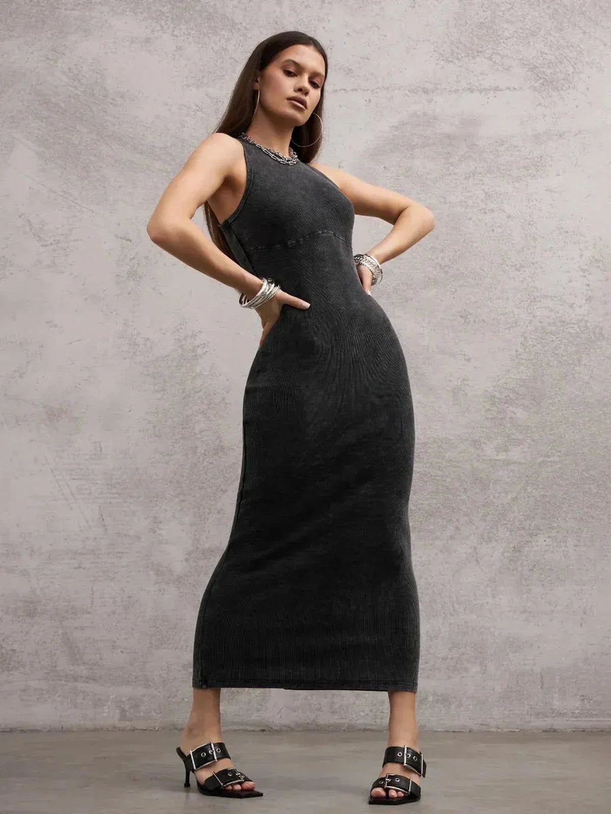 Model showcasing the Shadow Curve Maxi Dress in graphite, featuring a sleeveless bodycon style and minimalist design.