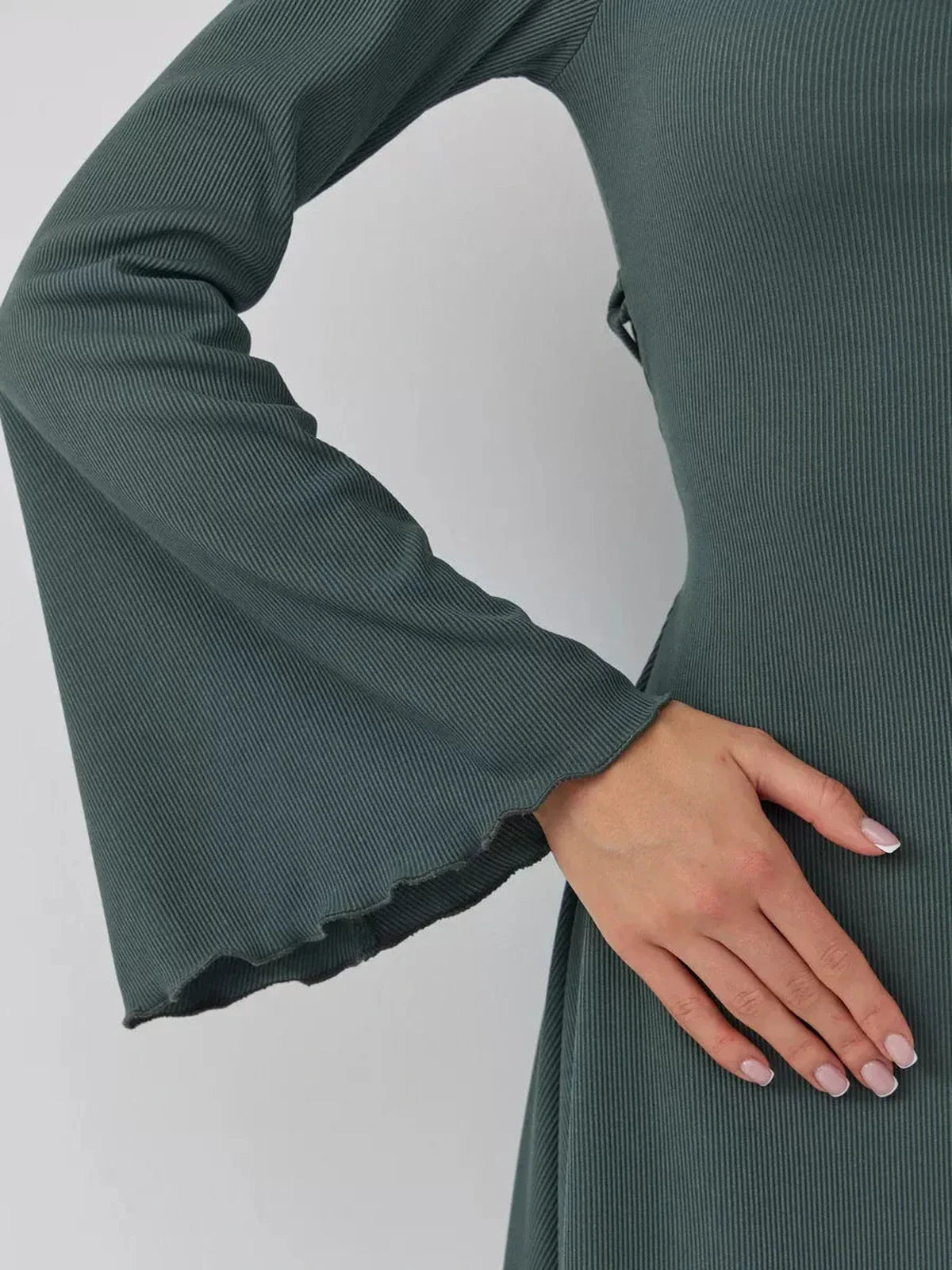 Detail of bell sleeve and textured fabric of the dark olive mini dress, Sculpt Flare.