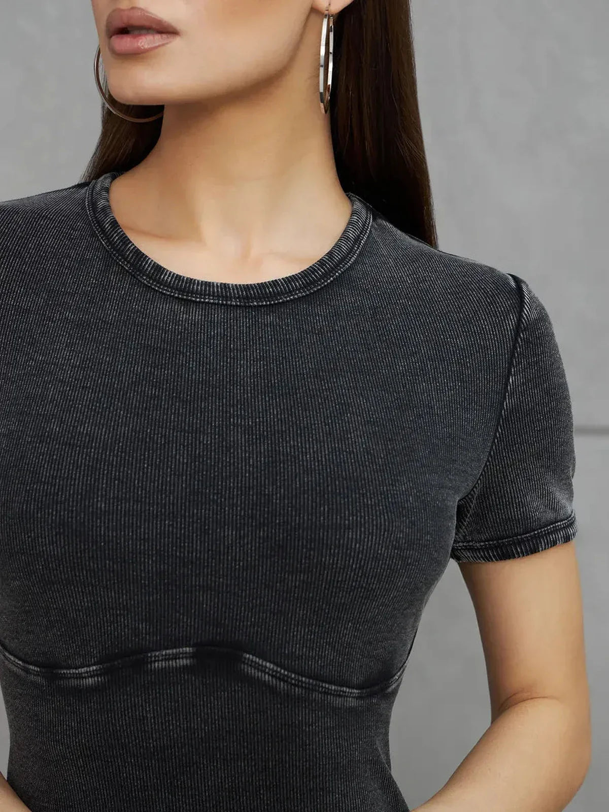 Close-up of a woman wearing the Graphite Form Maxi Dress, showcasing its soft stretch cotton and sleek design.