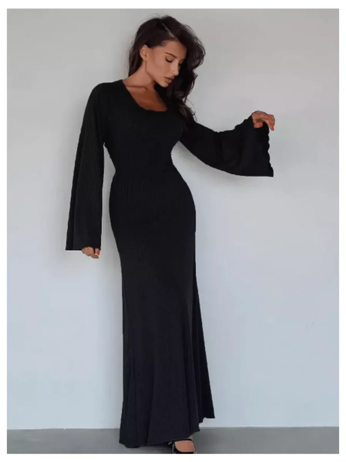 Noir contour maxi dress with flared sleeves, accentuating silhouette, ideal for formal events and summer occasions.