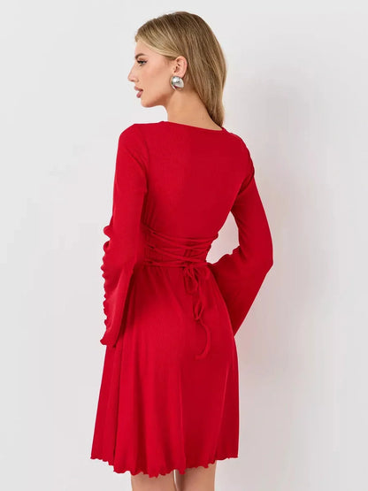 Back view of a woman in a red flare cutout mini dress with bell sleeves, showcasing a defined silhouette.