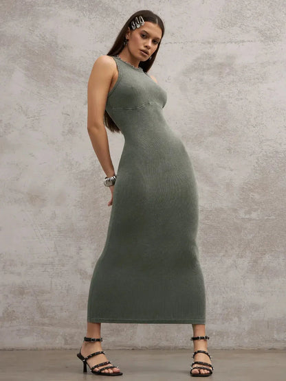 Sleek woman in a sleeveless washed khaki maxi dress showcasing sculptural minimalism and modern style.