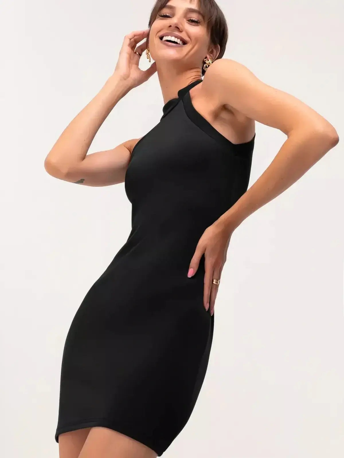 Model wearing a black midi dress with a halter neckline, showcasing a fitted and stylish look for evening events.