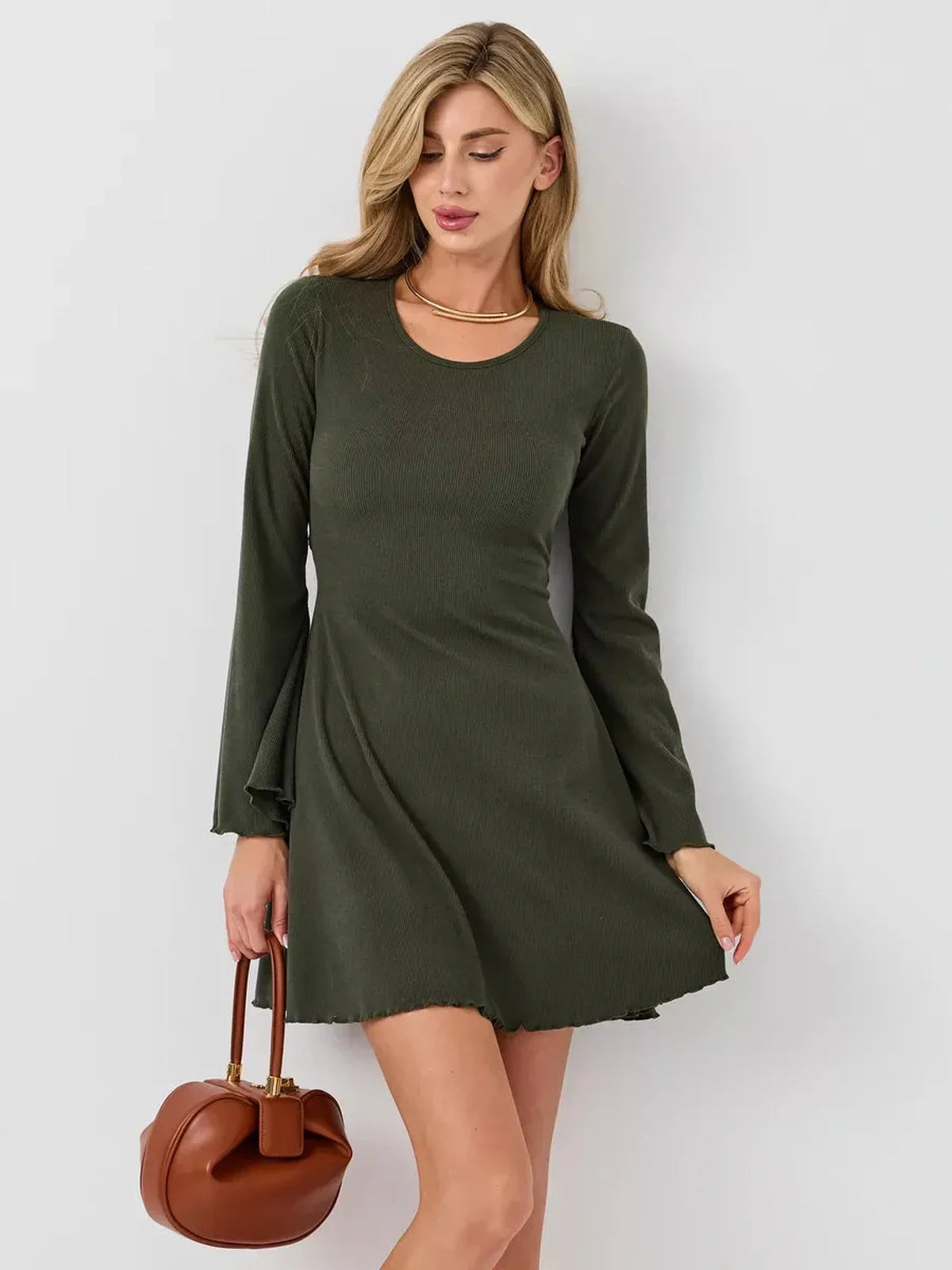 Model showcasing the Ivy Bell mini dress with bell sleeves, A-line silhouette, and premium ribbed knit fabric.