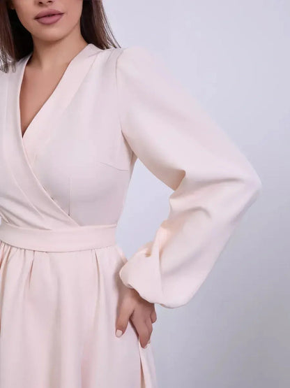 Champagne-toned mini dress with V-neck wrap silhouette and puff sleeves in soft ivory color.