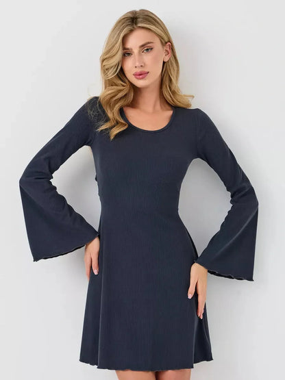Model wearing a Graphite Grace ribbed mini dress with bell sleeves, showcasing its flattering A-line silhouette.
