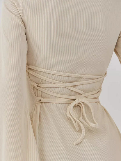 Detail of the Sculpted Grace mini dress showcasing a refined back tie design for a customized fit.