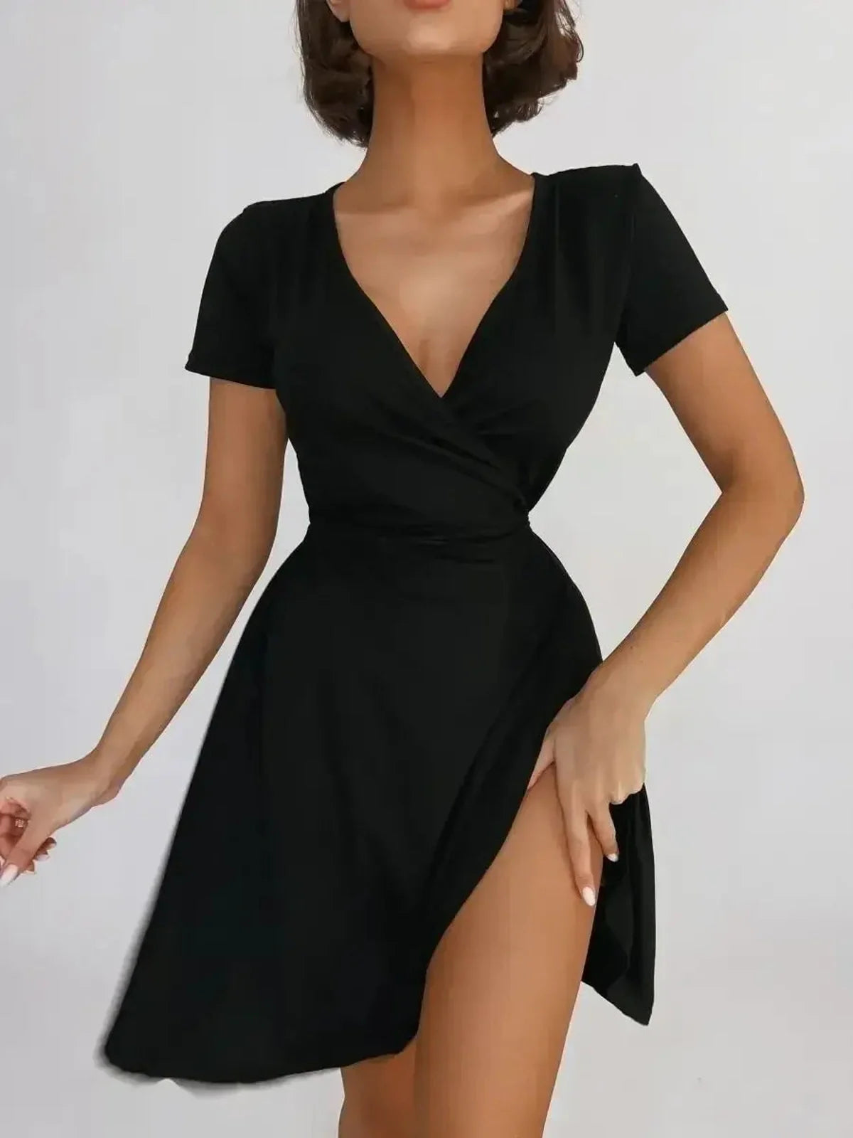 Sleek black mini dress with a deep V-neck and asymmetrical hem, perfect for stylish day-to-night wear.