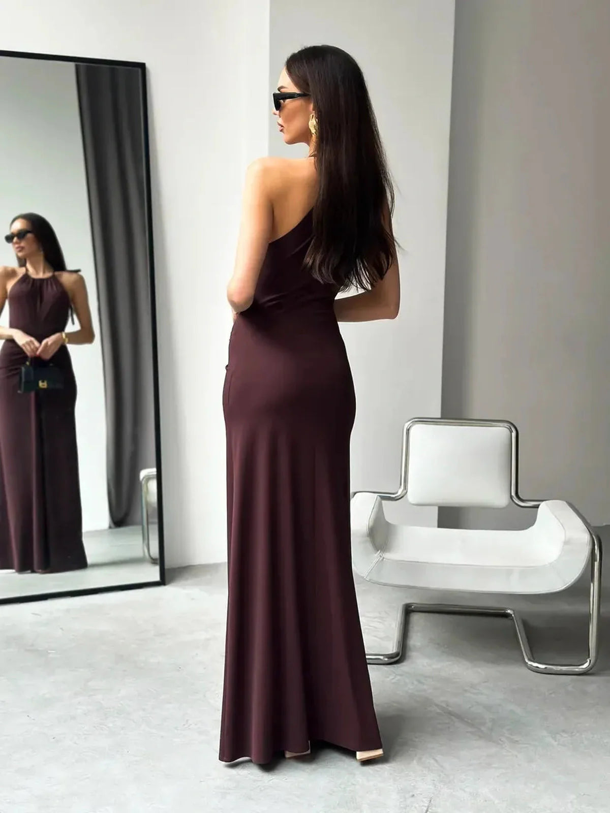 Model wearing the elegant Maxi Dress Sienna, showcasing its halter neckline and rich sienna hue.