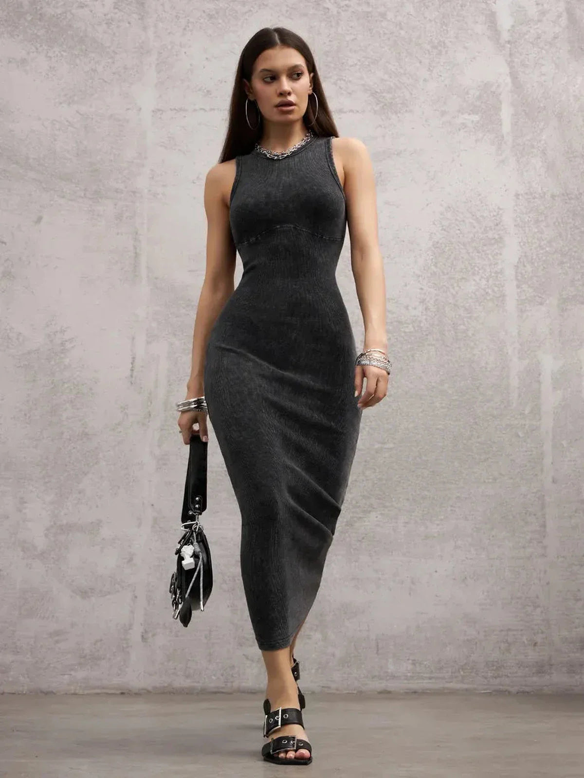 Model showcasing the Shadow Curve Maxi Dress in graphite, highlighting its sleek, sleeveless, bodycon design.
