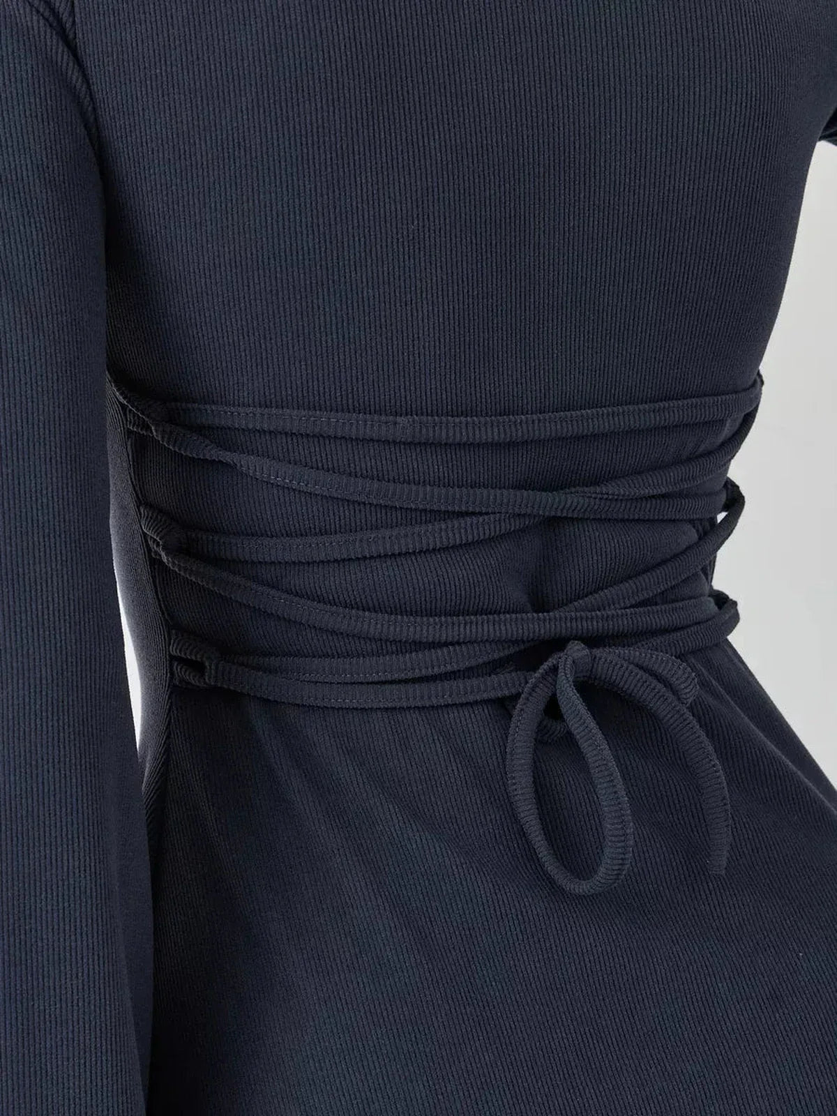 Close-up of Graphite Grace mini dress showcasing the lace-up back tie detail for adjustable fit and elegant style.